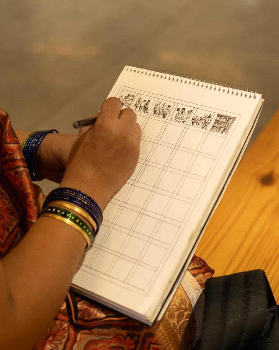 A hand sketching in a notebook