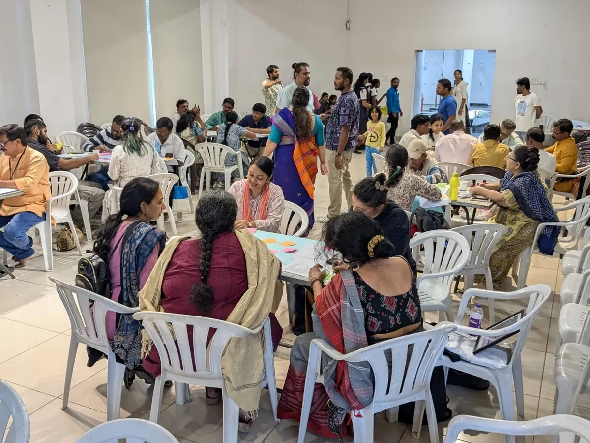 A packed hall of people at a community workshop